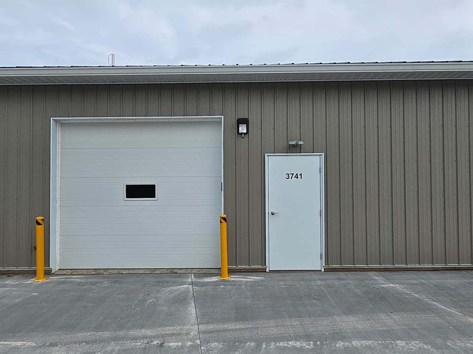 Closer front view of Buckeye Flex Space suites with business signs and vehicles in the lot